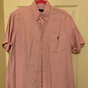 Men’s pink button up short sleeve collared polo.